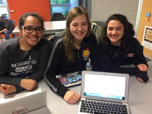 Three female students around a computer