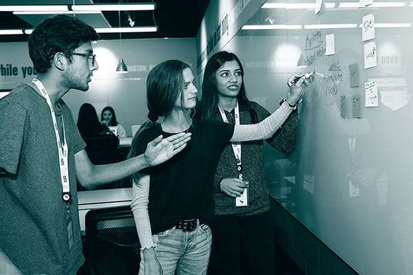 Students writing on whiteboard